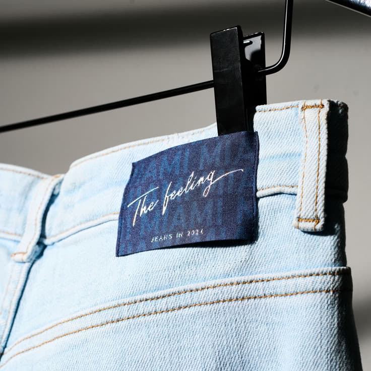 Woven tag on light-wash denim